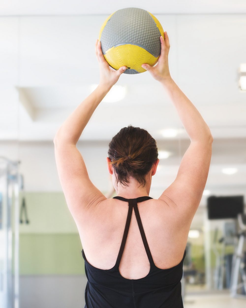 woman-lifting-fitness-ball_4460x4460